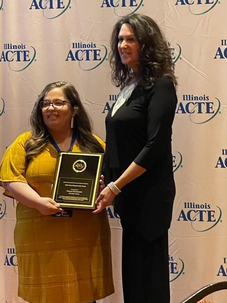 Krummrich pictured with award and IACTE President Krista Paul