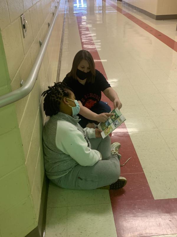 teacher and student learning in hallway