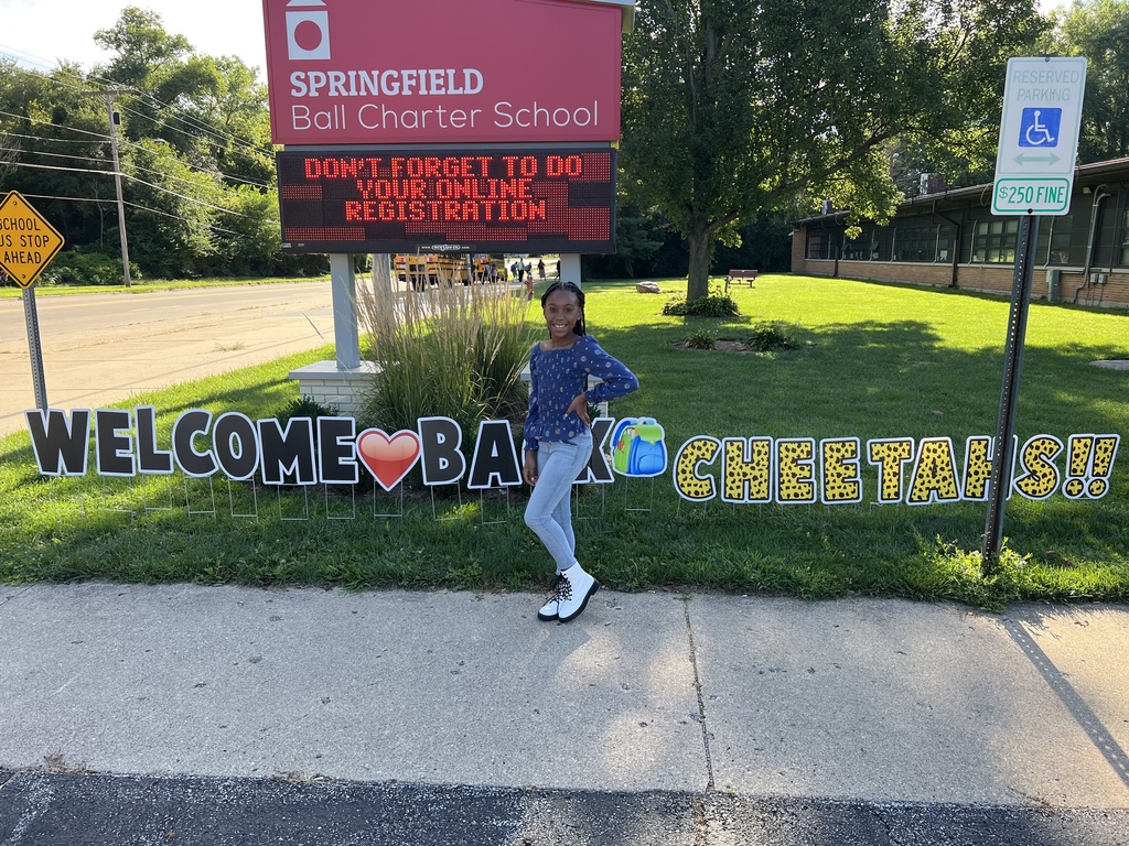 girl standing in front of Springfield Ball Charter School 