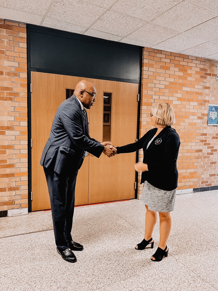 Kwame Raoul  and Jennifer Gill shaking hands 