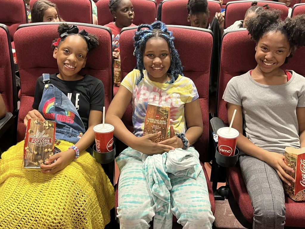 three students excited to watch the movie 