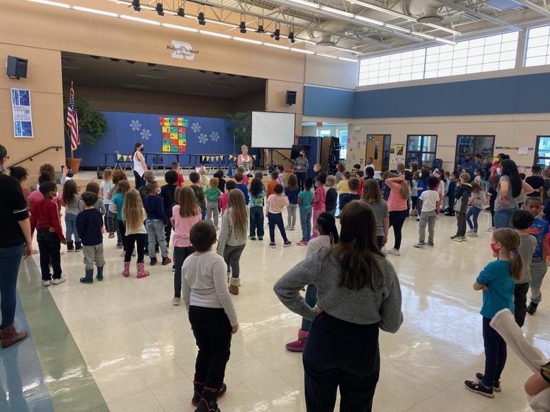 elementary students dancing in a cafeteria setting