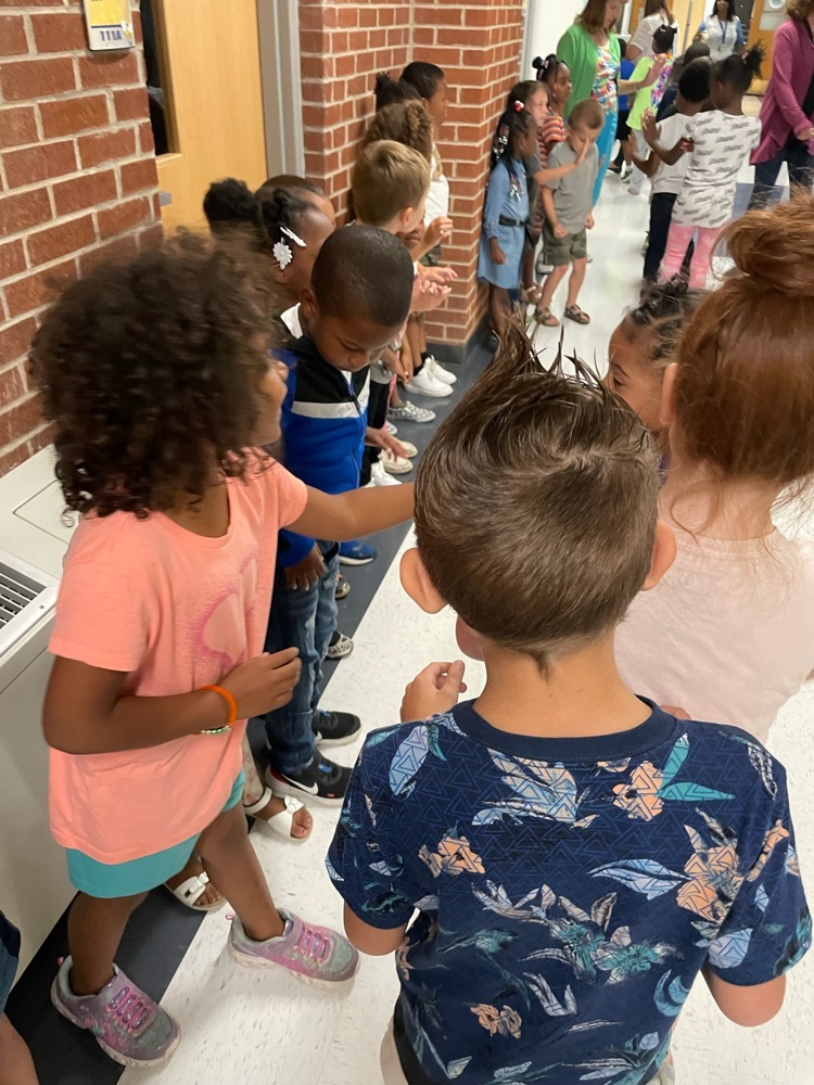 students in a line giving high fives 