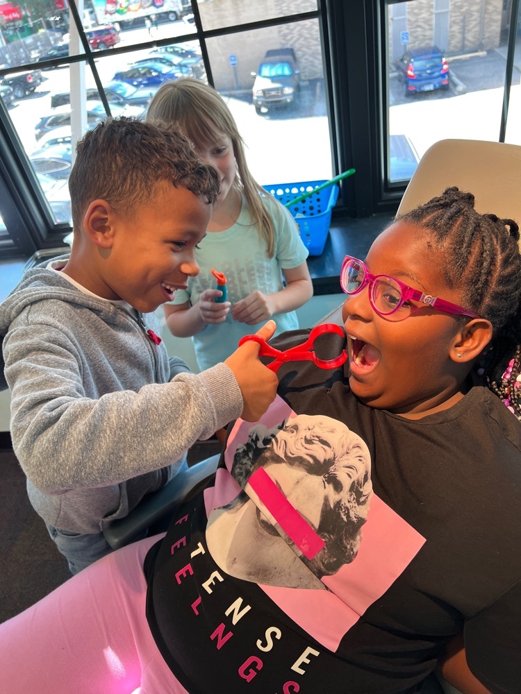 student pretending to pull another students tooth