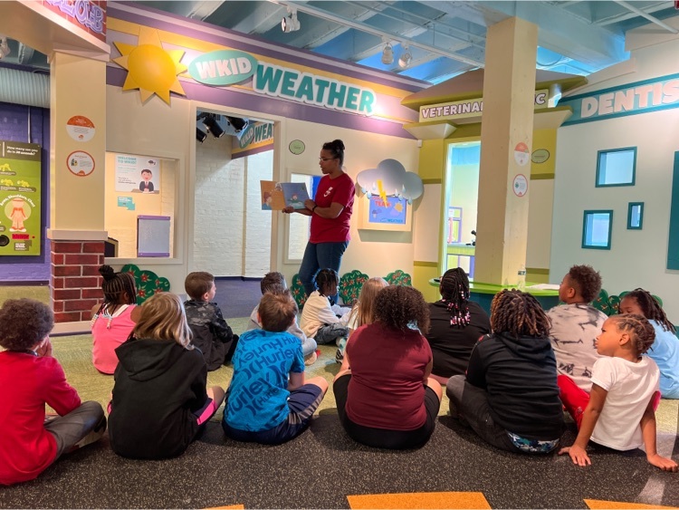 teacher reading a book to her students 