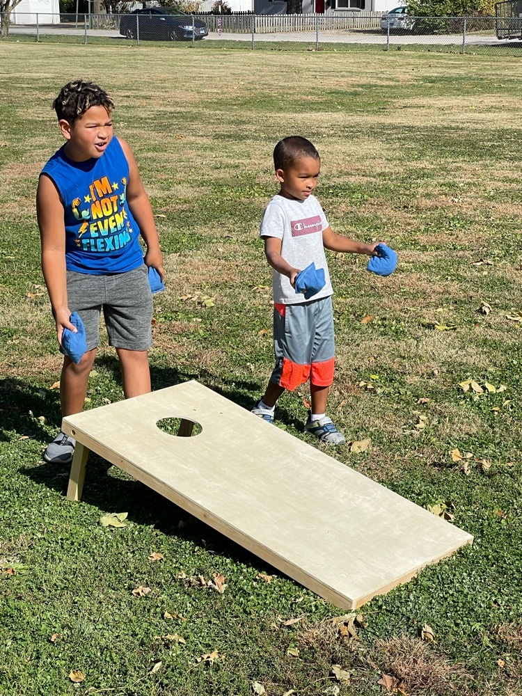 two students playing bags