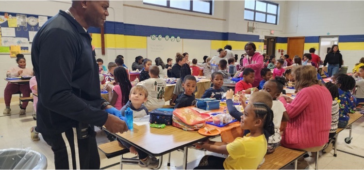 students and staff eating lunch together 