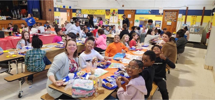 students and staff eating lunch together 