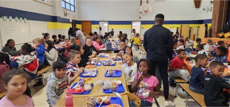 students and staff eating lunch together 