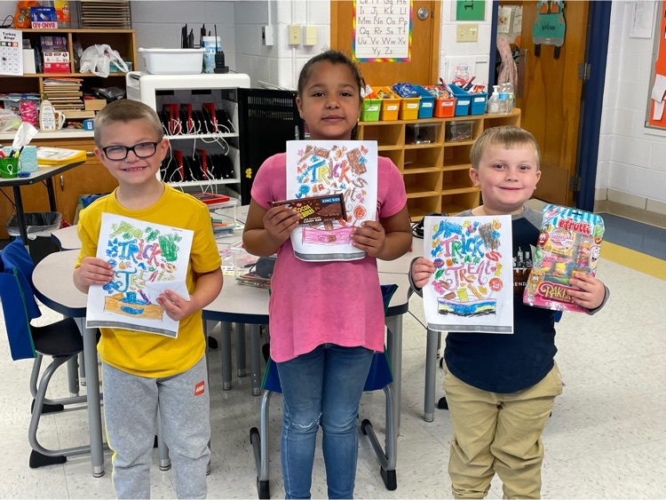 students holding their color sheet and prize 