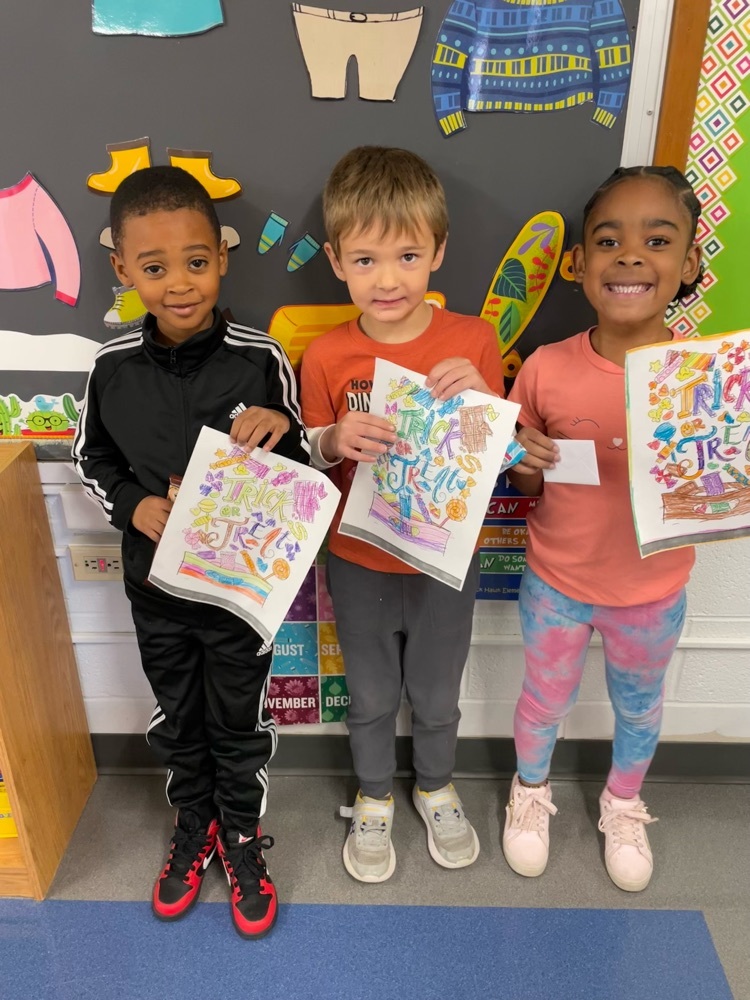 students holding their color sheet and prize 