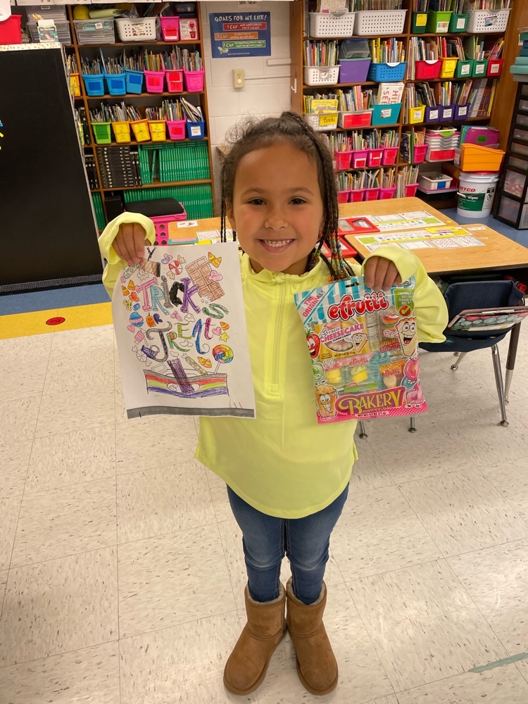 students holding their color sheet and prize 