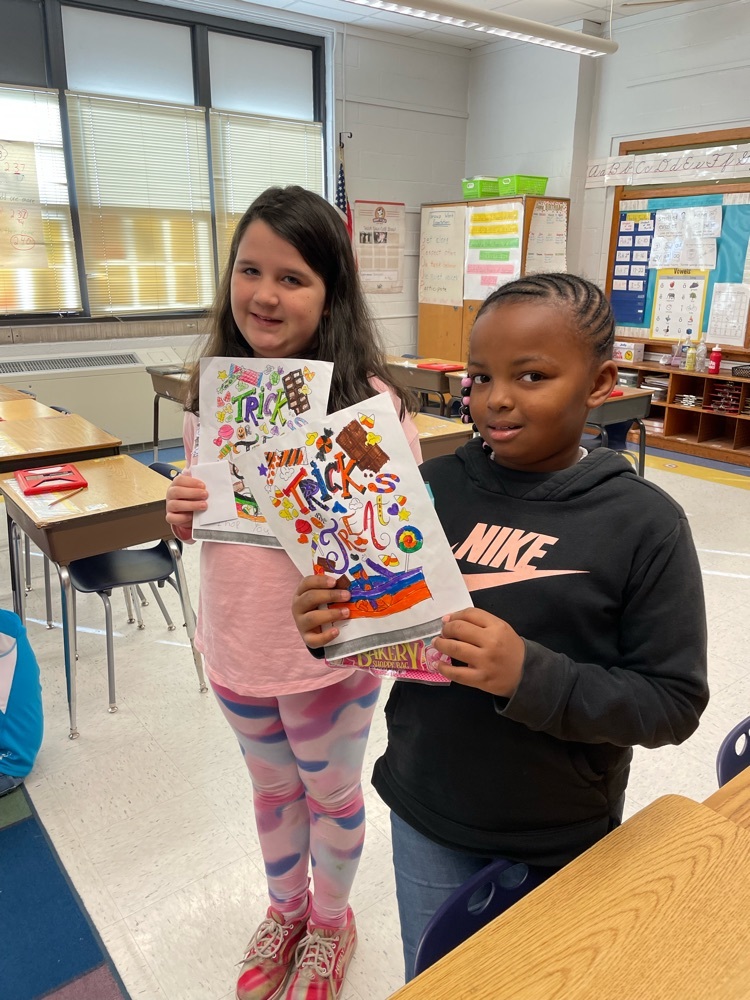 students holding their color sheet and prize 